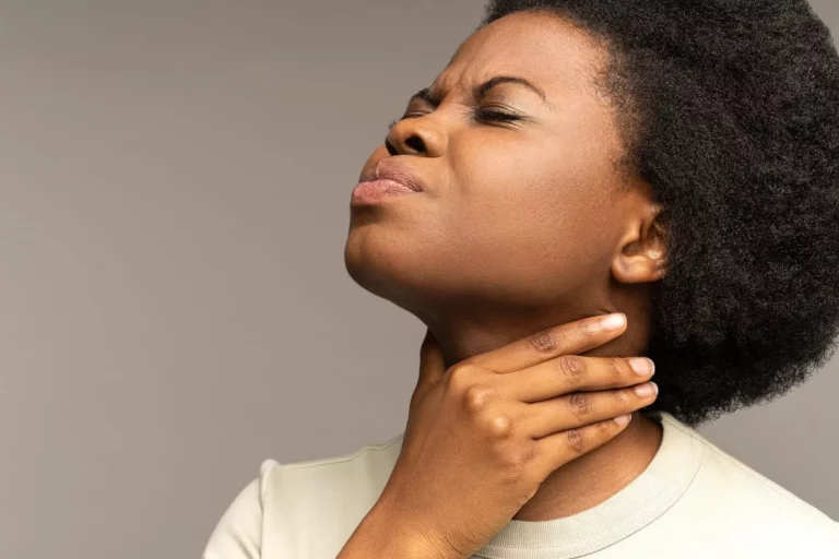 Woman experiencing symptoms associated with thyroid dysfunction