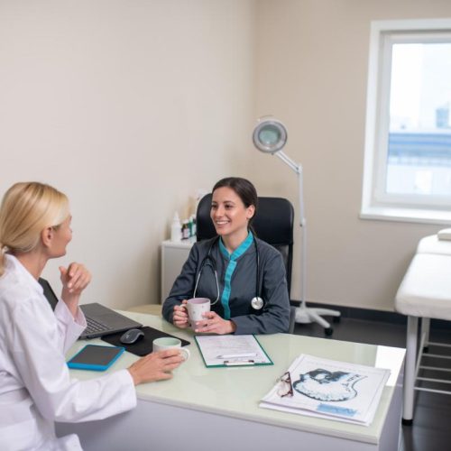 two-women-having-a-conversation-in-a-light-room-BUBQNFX-sm